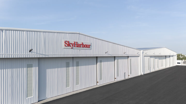 Long metal-clad Sky Harbour hangar building in bright sunlight
